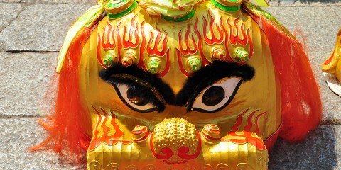 Closeup of a Lion dance mask on the ground